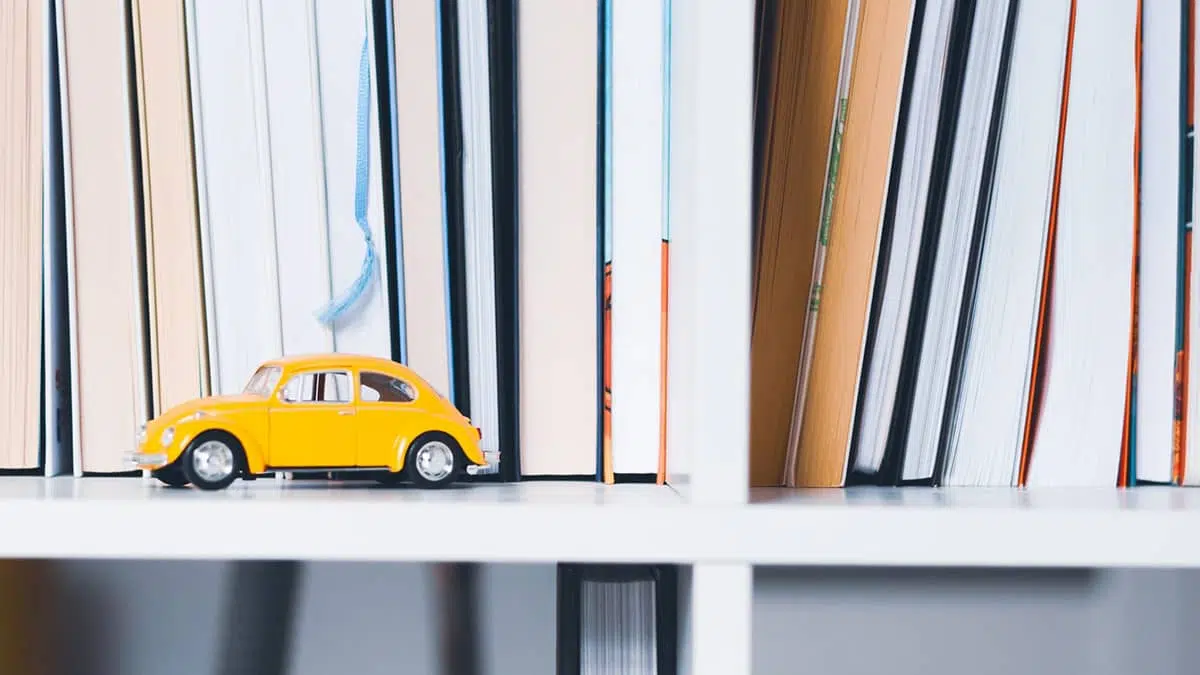 Yellow toy car on a bookshelf to illustrate website traffic
