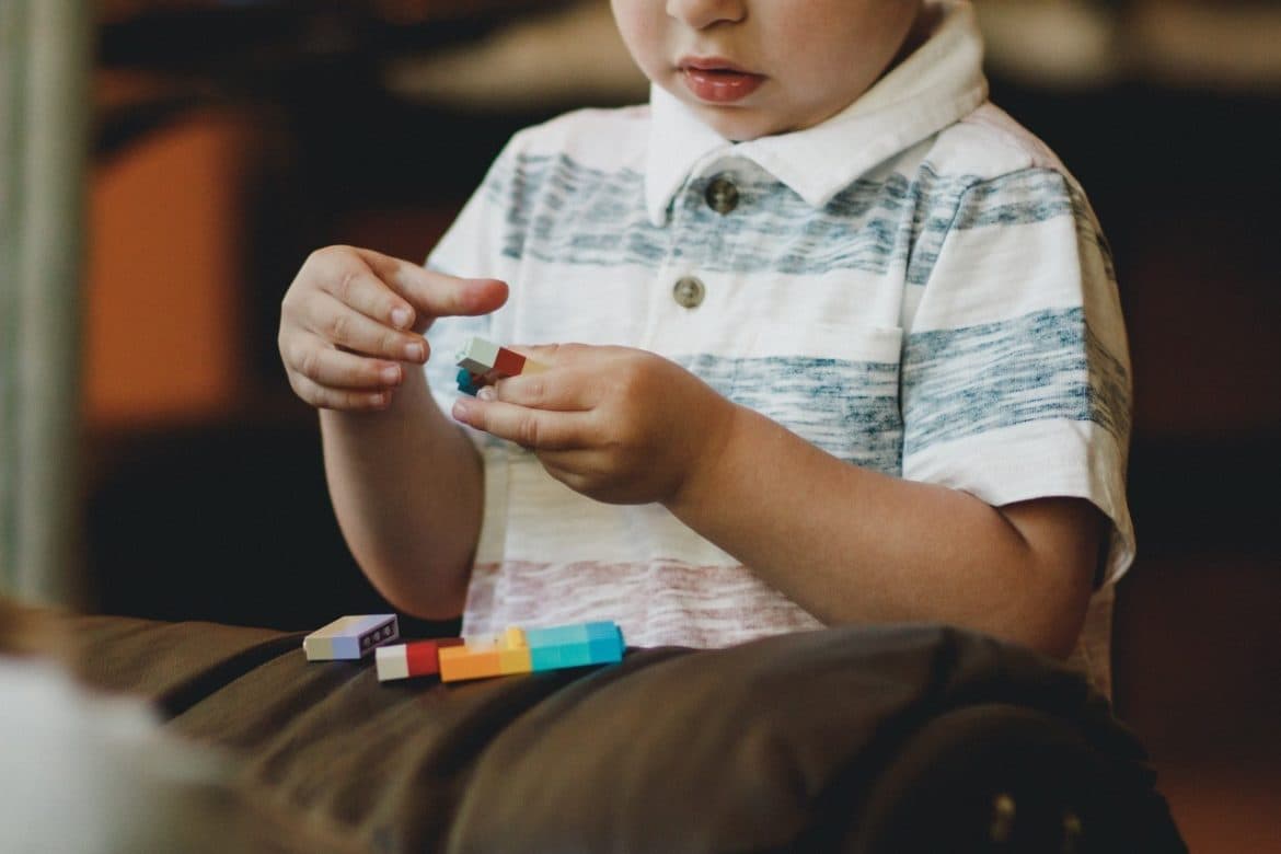 Creating growth - a child playing with lego