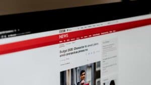 Computer screen with BBC News article about COVID-19