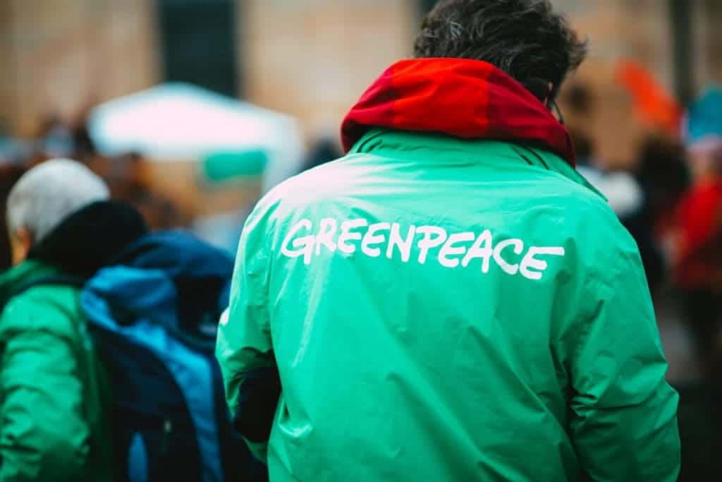 Greenpeace member wearing the iconic green jacket.