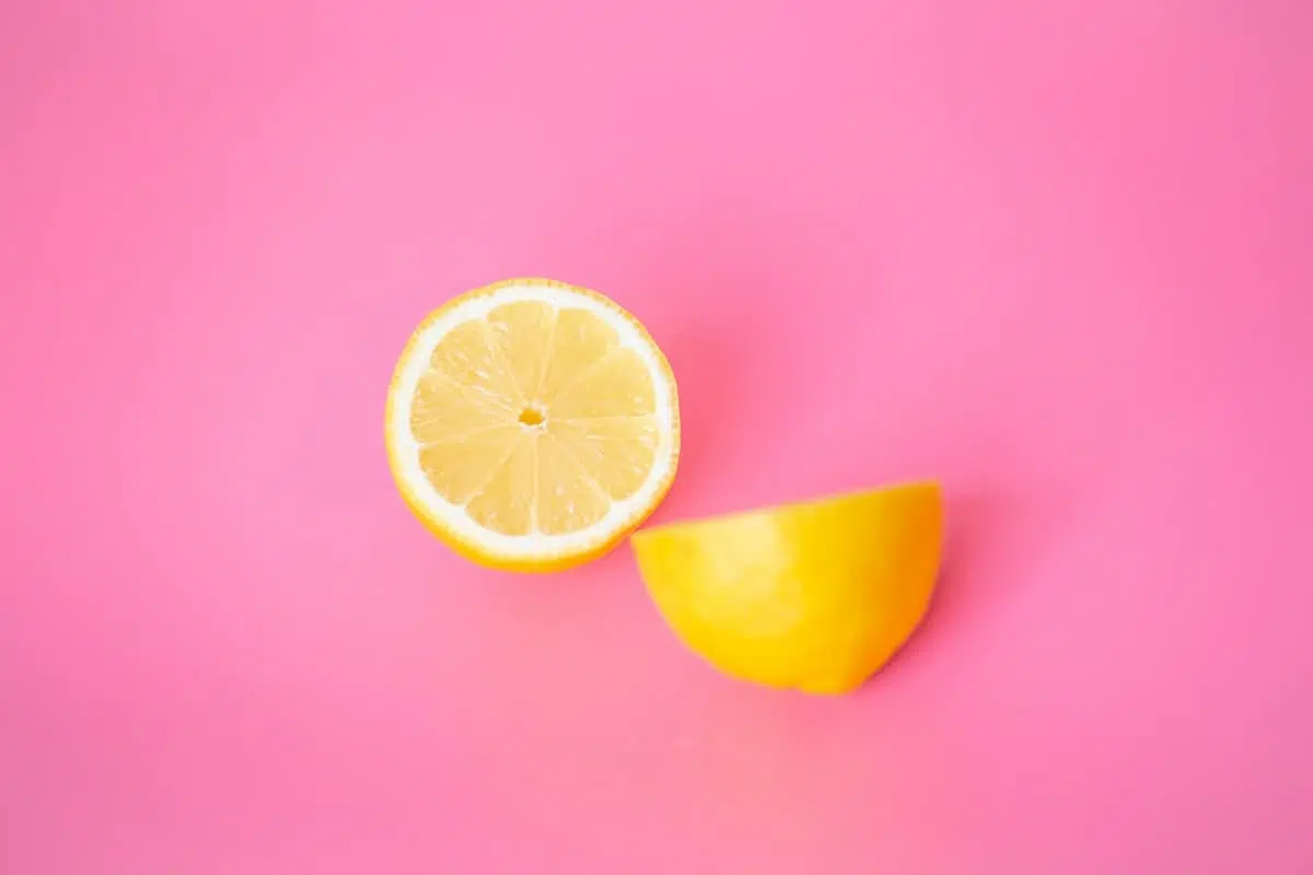 Yellow lemon segments on a pink background