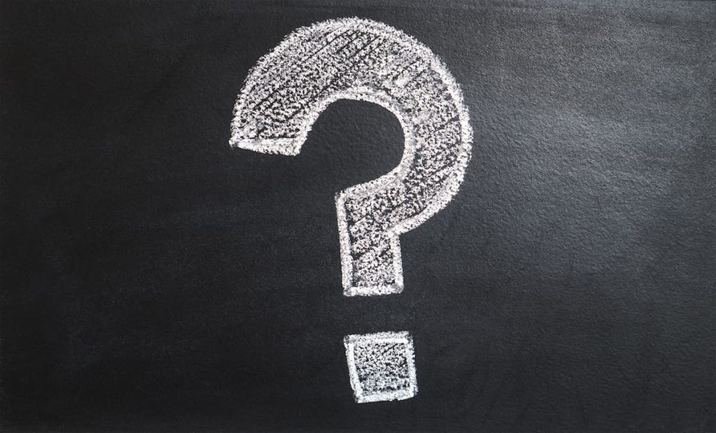 White chalk question mark on blackboard